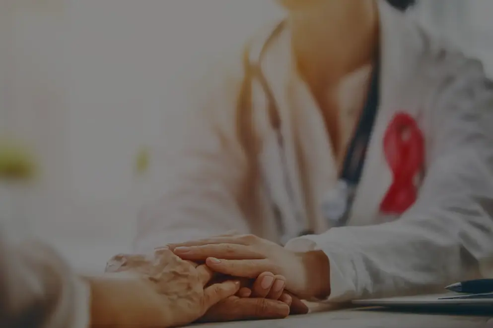 Doctor holding patients hand in consultation